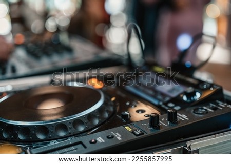 DJ Spinning. mixing and scratching in a night club. DJ playing music at mixer. Closeup. Party. Dj playing music on rave party in nightclub. Disc jockey mix