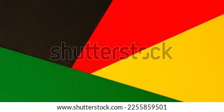 Black History Month color background. African American history month celebration. Abstract red, yellow, green color flag on black paper background