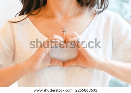 Woman making hand in heart shape, self love, self care. Mindfulness spiritual living lifestyle. Royalty-Free Stock Photo #2255863631