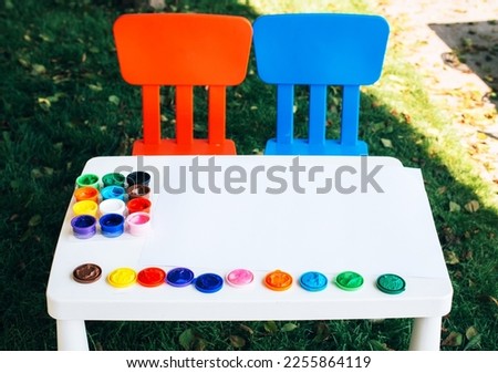 Empty kids table with gouache paints . mockup