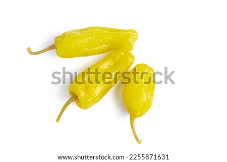 Three pickled yellow peppers, pepperoncini or friggitelli isolated on white background. Hot pepper marinated, brined. Traditional Italian and greek cuisine, ingredient for salad, pasta, sauce. Royalty-Free Stock Photo #2255871631