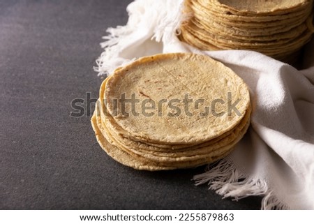 Corn Tortillas. Food made with nixtamalized corn, a staple food in several American countries, an essential element in many Latin American dishes. Royalty-Free Stock Photo #2255879863