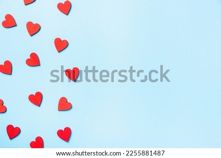 Valentines' day background. red hearts composition greeting card for love Valentines day concept isolated on blue background with copy space. Top View flat lay from above