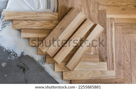 Top view of parquet boards installing in herringbone Royalty-Free Stock Photo #2255885881