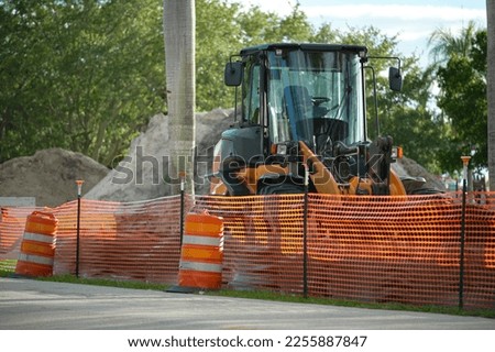 Protective restriction barrier at industrial construction site. Safety mesh fence for pedestrians