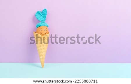 Cute easter bunny or rabbit with a smiling egg face in an ice cream cone, spring holiday, greeting card
