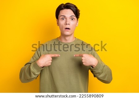 Photo of astonished man wear khaki clothes arm direct himself impressed choice isolated on yellow color background