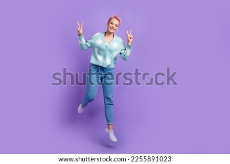 Full body length photo of youngster hipster carefree lady jumping wear new collection outfit show v-sign blog isolated on purple color background