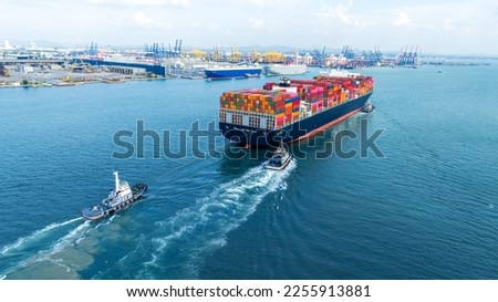 Tub Boat with Stern of cargo ship carrying container and running for import goods from cargo yard port to custom ocean concept technology transportation , customs clearance.