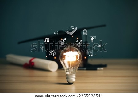 E-learning graduate certificate program concept. lightbulb showing graduation hat, and education icons. Internet education course degree, Idea of learning online class.Webinar Online Courses Royalty-Free Stock Photo #2255928511