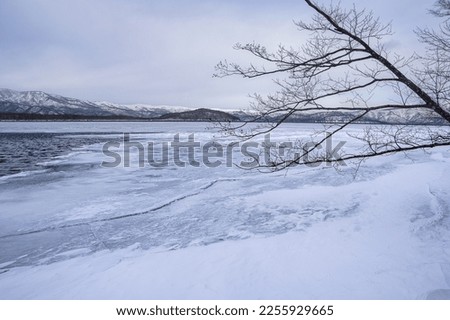 Ice covered lake in winter. Lake Kussharo in Hokkaido, Japan. Royalty-Free Stock Photo #2255929665