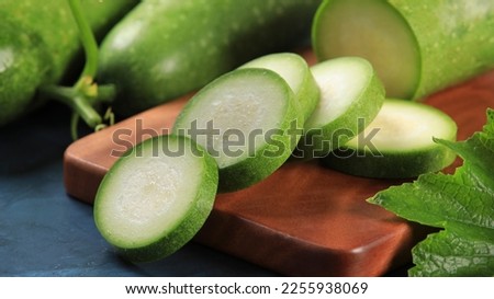 Winter melon slices in the bowl prepare to cooking on tableware made of wood Royalty-Free Stock Photo #2255938069