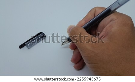 Hand with a pen. Isolated on white background