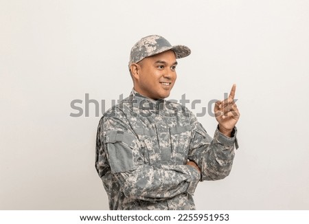 Pointing blank space. Asian man special forces soldier standing in studio. Commander Army soldier military defender of the nation in uniform standing on white background.