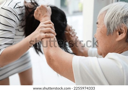 Angry asian old elderly patient with mood disorders,violent aggressive abnormal behavior,personality changes to violence,losing control over emotions,physical health problems,mental disorder concept Royalty-Free Stock Photo #2255974333