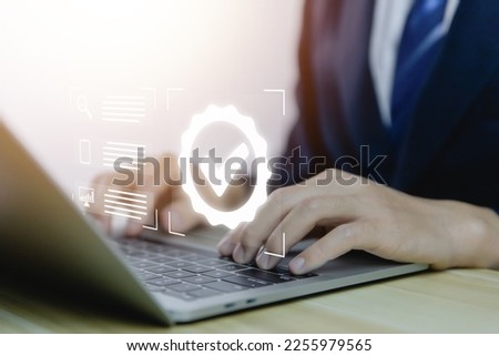 Businessman using a laptop showing check mark digital technology icon symbol. Best quality assurance service concept, product performance assurance, and industry-leading ISO certification.