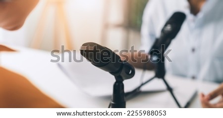 Young Asian woman use microphones wear headphones with laptop record podcast interview for radio. Content creator concept. Royalty-Free Stock Photo #2255988053