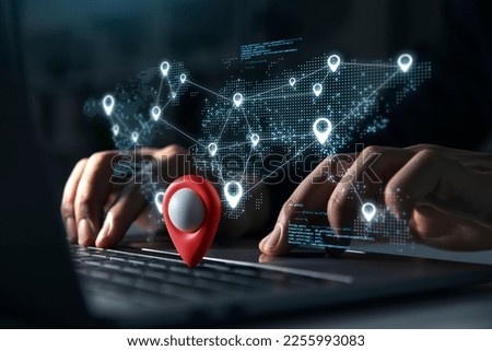Young man using laptop with Blue markers with user icons on the map, Geolocation, Global network concept. Royalty-Free Stock Photo #2255993083