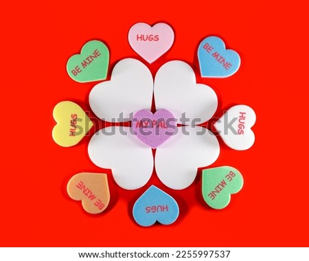 Floral arrangement of different color hearts on a red background, Valentine's day concept. Royalty-Free Stock Photo #2255997537
