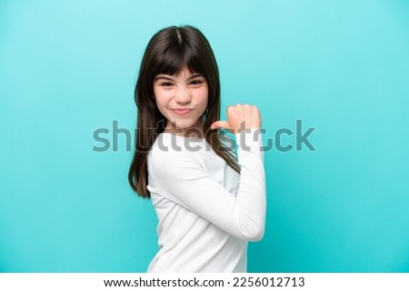 Little caucasian girl isolated on blue background proud and self-satisfied Royalty-Free Stock Photo #2256012713
