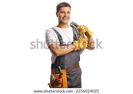 Young electrician carrying cables on shoulder isolated on white background Royalty-Free Stock Photo #2256024025