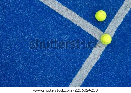 balls on a blue paddle tennis court Royalty-Free Stock Photo #2256024253