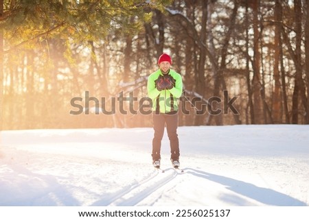 Cross country skiing in winter on snowy track, sunset background, habits for lifestyle.