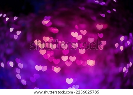  Abstract images of beautiful fresh pink and purple colored soft and swirl heart bokeh from ornamental lights flickering in the garden. Blurry background for Autumn season, Valentine or Love concept.