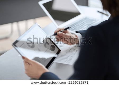 Asian business person having a meeting with a tablet