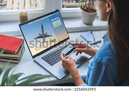 Online booking and buying plane tickets using computer and credit card Royalty-Free Stock Photo #2256042493
