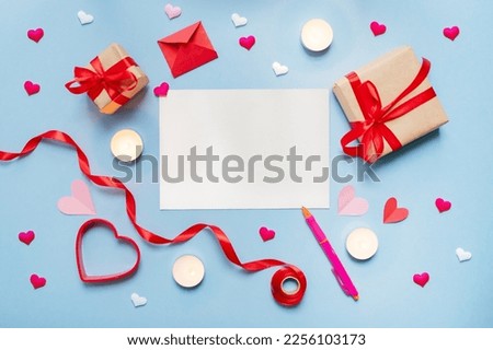 various valentine's day decorations and gifts, empty blank on blue background. copy space. top view. flat lay