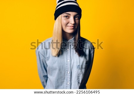 Stock photo of young pretty girl looking at camera in studio.