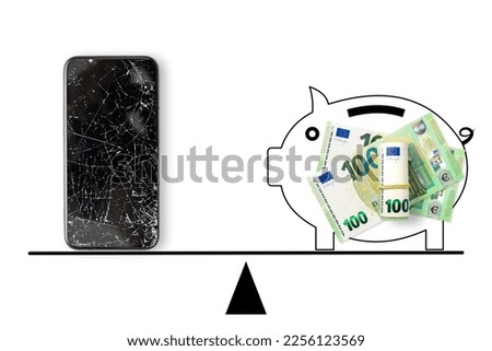 Black broken touch screen phone and 100 euros banknotes on scales. 