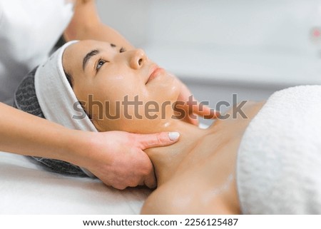 SPA and wellness day. Neck massage performed on attractive Asian woman beautiful shiny clear skin. . High quality photo