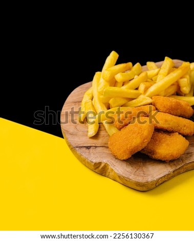 Chicken Nuggets and French Fries on wooden board