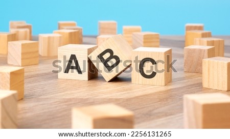 ABC written on wooden blocks, business concept, blue background