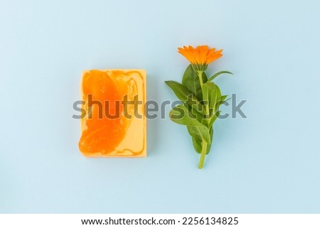 Natural soap and calendula flowers.Home-made soap with marigold. Alternative medicine and herbal treatment.Flat lay, copy space