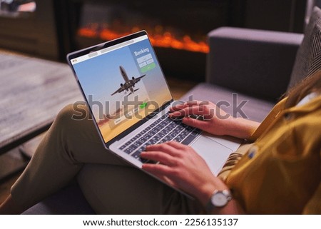 Online booking plane tickets using computer  Royalty-Free Stock Photo #2256135137