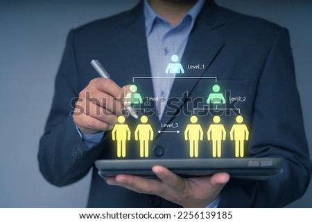 Businessman showing virtual graphic human icon for human development recruitment leadership and customer target group concept. HRM or Human Resource Management. Hr.