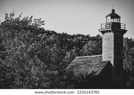 Black and white photo of the Grand Island Lighthouse in Pictured Rocks National Lakeshore near Munising Michigan.