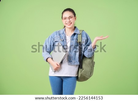 Photo of young Asian college girl on green background