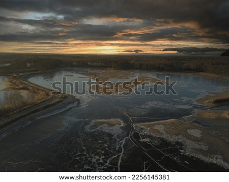 frozen river in dramatic sunset