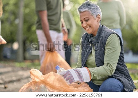 Garbage, volunteer and senior woman cleaning trash, pollution or waste product for environment support. Plastic bottle container, NGO charity and eco friendly community help with nature park clean up Royalty-Free Stock Photo #2256153761