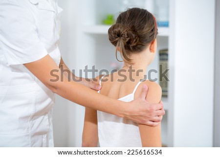 Chiropractor doing adjustment on female patient Royalty-Free Stock Photo #225616534