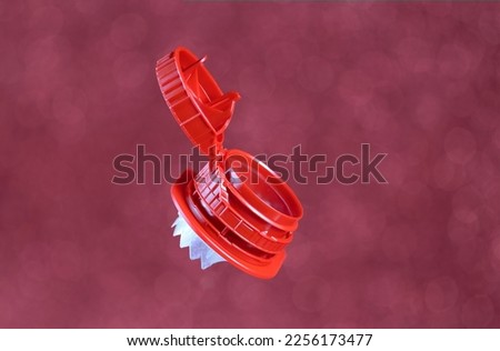 Innovative and useful cap attached to the container to avoid its loss and to be recycled together with the brick, isolated on a magenta background Royalty-Free Stock Photo #2256173477