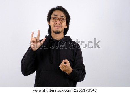 Asian man communicated by Sign language with 'I Love you' hand gestures