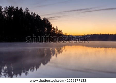 sunset over the lake, calm and bright sky karelia