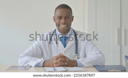 African-American Doctor Smiling at Camera while in Clinic