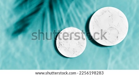 Top view of marble podium stand in swimming pool water with palm shadow. Summer tropical background for luxury product placement.  Royalty-Free Stock Photo #2256198283