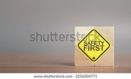 Work safety concept. Safety first text yellow in wooden cube and copy spec. Safety first sign on virtual screen. Hazards, protections, regulations and insurance, Zero accidents, Protection dangerous.